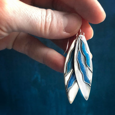 Silver Gentle Current Earrings thin and long with two blue currents made with turquoise held by fingers. Empowering jewelry healing jewelry handmade in Vermont. 